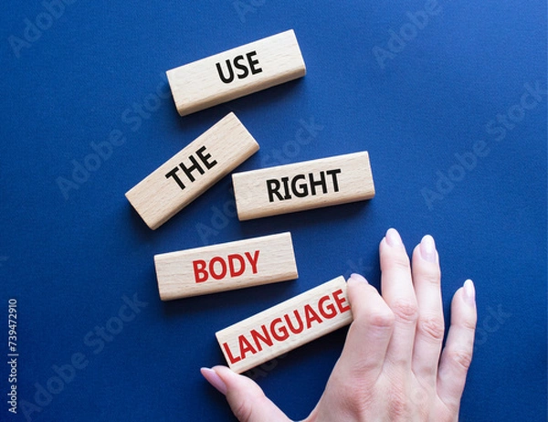 Fototapeta Use the right Body Language symbol. Concept words Use the right Body Language on wooden blocks. Businessman hand. Beautiful deep blue background. Business concept. Copy space