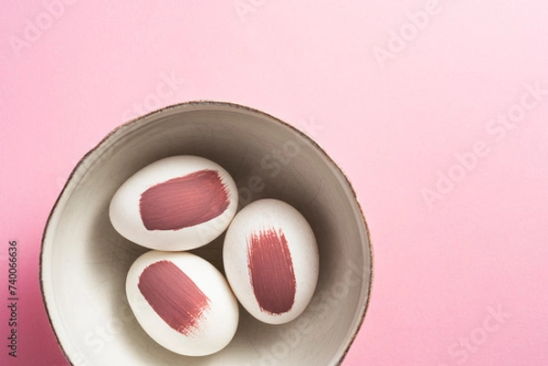 Fototapeta Purple painted easter eggs in a bowl on pink background