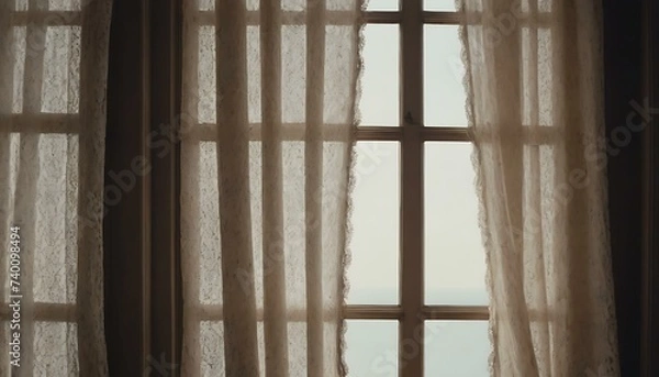 Fototapeta A pair of vintage, lace curtains gently swaying in an open window