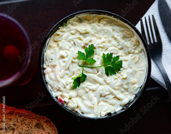 Fototapeta Healthy squid salad with cucumber, mayonnaise and parsley. Russian cuisine