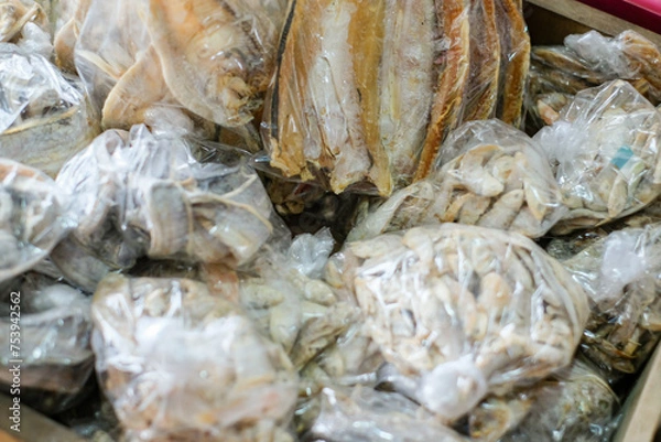 Fototapeta Salted fish or dried fish is fish that is preserved by salting and drying in the sun. It is being sold at fish markets. This is a famous traditional side dish in Indonesia.