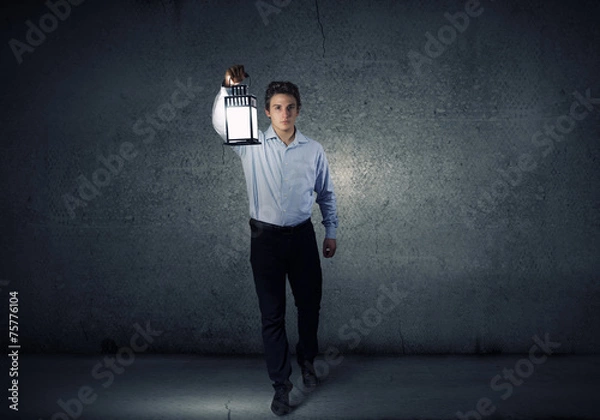 Fototapeta Businessman in search in darkness