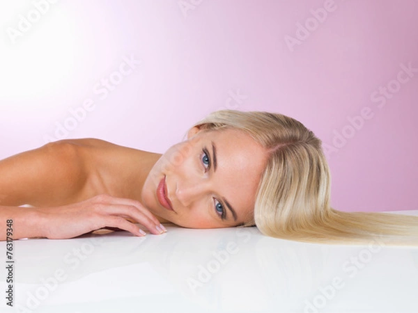 Fototapeta Studio, portrait and smile of woman with skincare for health, glow and shine of skin of girl. Pink background, adult and female person with soft, face and results from dermatology and cosmetics