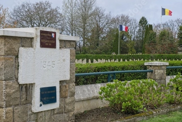 Fototapeta Sainte Anne d'Auray, France - Mar 27, 2024: Breton National Necropolis contains the graves of French and Belgian soldiers who were killed during First and Second World War. Cloudy day. Selective focus