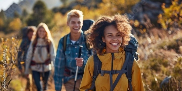 Fototapeta Group of friends hiking together outdoors exploring the wilderness and having fun