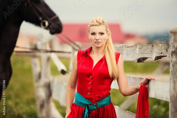 Fototapeta Beautiful young woman with a horse outdoor