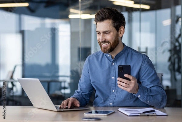 Fototapeta Professional businessman at work with laptop and smartphone