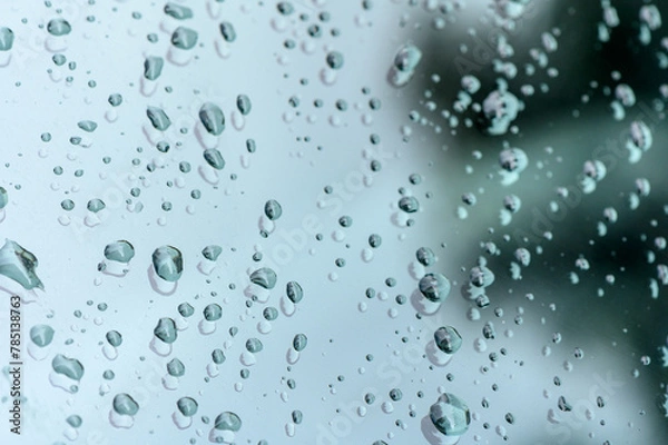 Obraz raindrops on glass window of car with cloudy sky in the background 1