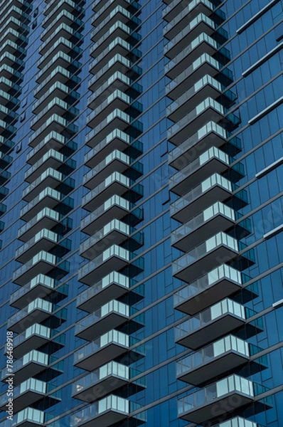 Fototapeta Abstract Side View of a Blue and White Glass Building Wall.