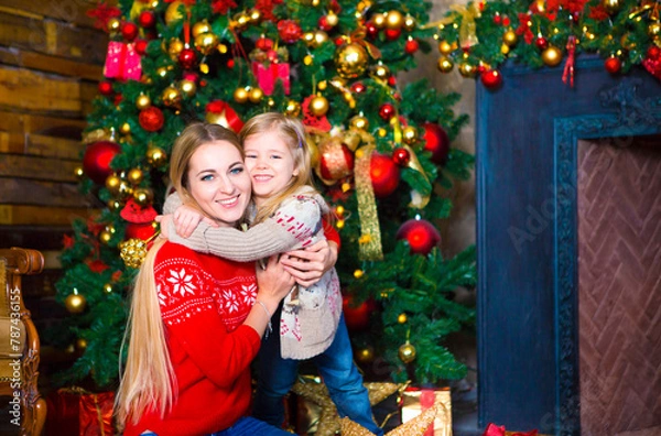 Fototapeta Hugging mother and daughter. Christmas happiness concept