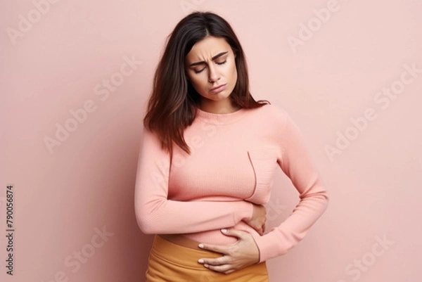 Fototapeta young beautiful woman suffering from stomach cramp