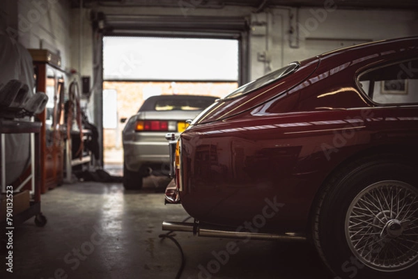 Fototapeta Classic cars being restored in a vintage vehicle garage workshop