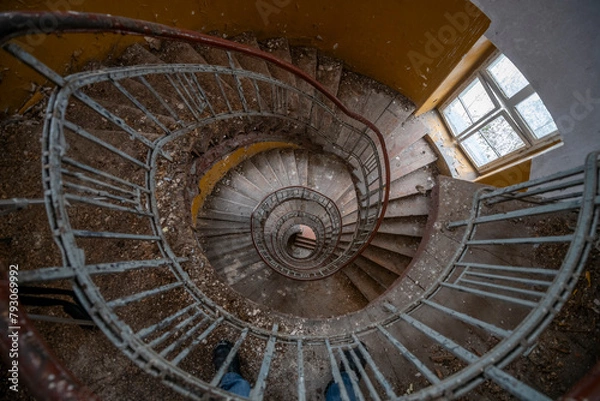 Fototapeta Exploration of the historic old stone mill with a spiral staircase in Southern Poland, Europe, in Winter