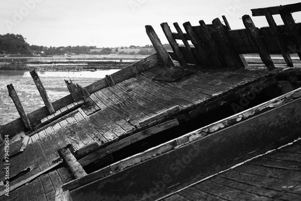 Fototapeta A wreck of a wooden boat. Black and white view of the deck of an abandoned ship.