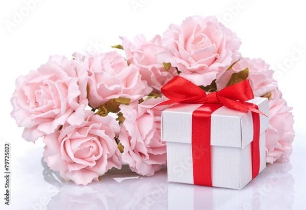 Fototapeta pink flowers and  gift box with red ribbon and bow on a white ba