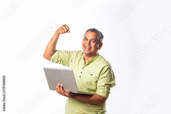 Fototapeta Indian asian mid age man using laptop against white background