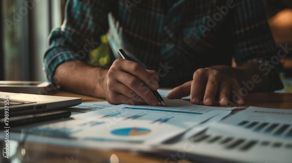 Fototapeta A business owner reviewing financial reports, ensuring the company's financial health. Diligence and work, team and trust, profit