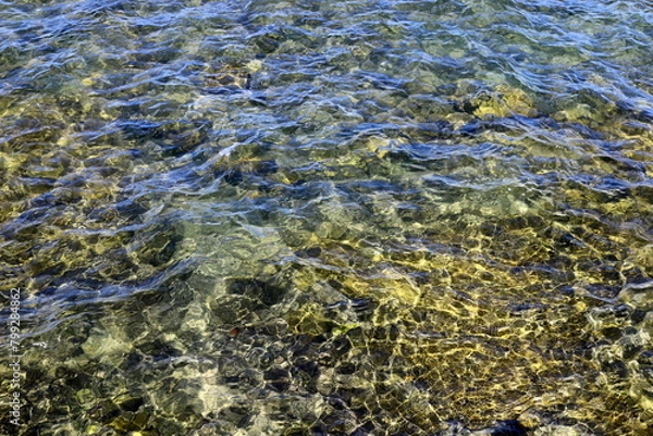 Fototapeta The color of water in the Mediterranean Sea in shallow water. Natural abstract background.