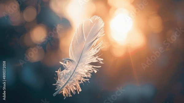 Fototapeta The simplicity of a feather drifting, capturing the essence of gentleness for awareness. World Suicide Prevention Day, September 10