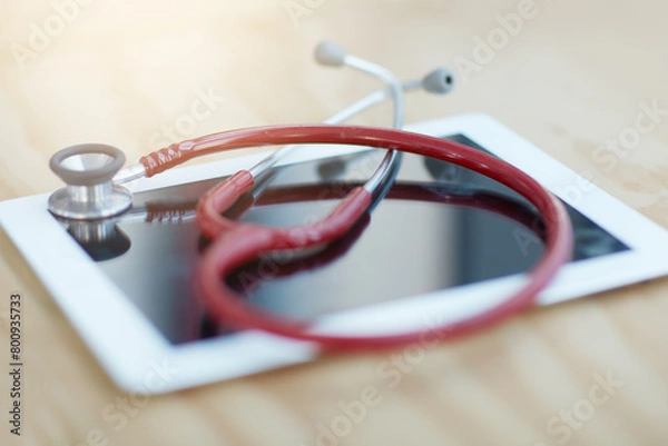 Fototapeta Stethoscope, tablet and medical tools on desk in hospital office for consultation or checkup. Phonendoscope, digital technology and healthcare equipment for telehealth information or data in clinic.