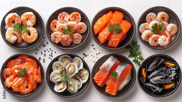 Fototapeta Seafood set in black bowls on white background, top view