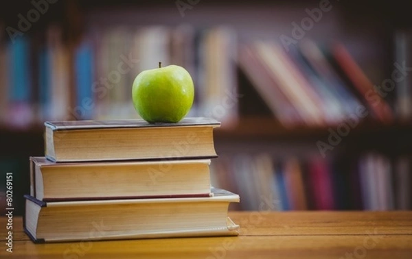 Fototapeta Apple on pile of books