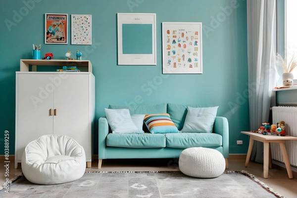 Fototapeta White cushions on aquamarine sofa next to cabinet and rug in kid's room with posters