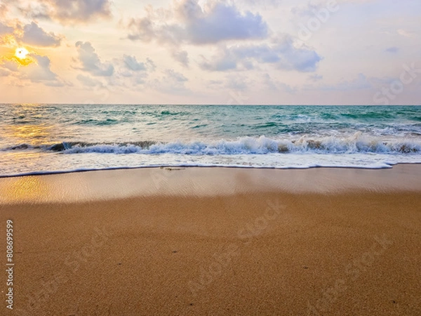 Fototapeta The sky cloud. Ocean waves crashing onto the shore. with the evening atmosphere. sunset view That reflects the light of the sea and the beautiful beach. Feeling vacation and relaxation with nature.