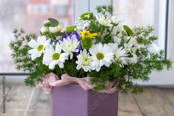 Obraz bouquet of white chrysanthemums and daisies with greenery in lilac box. soft focus