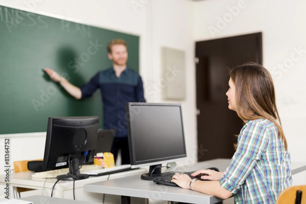 Fototapeta Teacher educating a pupil in a classroom