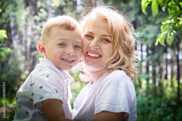 Fototapeta Tender Moment Between Mother and Child in a Sunlit Forest