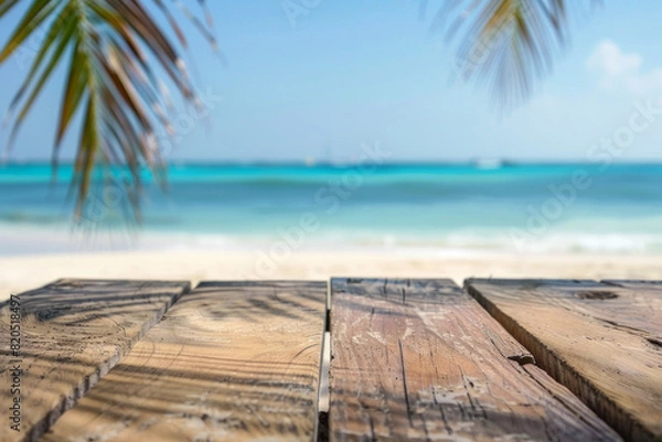 Fototapeta A wooden desk top with blurred background of beach. Good for background 