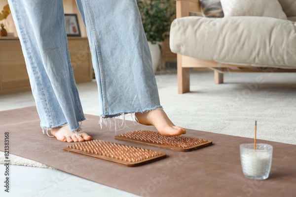 Fototapeta Young woman with Sadhu board at home