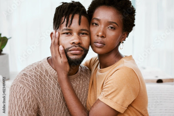 Fototapeta Portrait, black couple and embrace in living room, man and woman with love, romance and relax in home for break. House, African person and partner in lounge, hug and serious of marriage or commitment