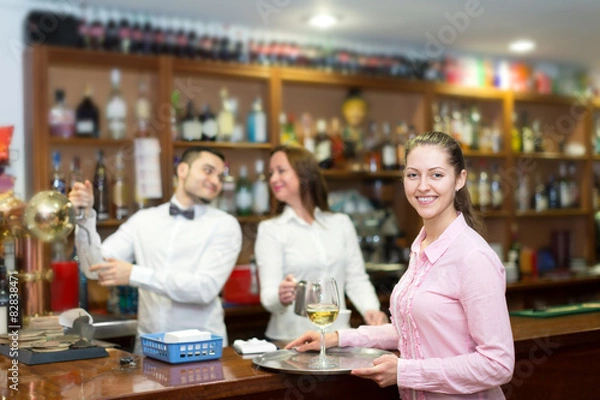 Fototapeta Waitress holding tray with glasses