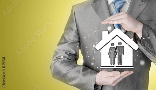 Fototapeta businessman protecting family in home with hands