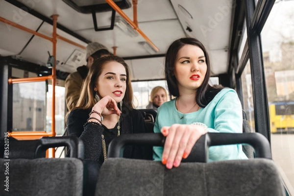 Fototapeta girls riding public transportation to work, study. show the way