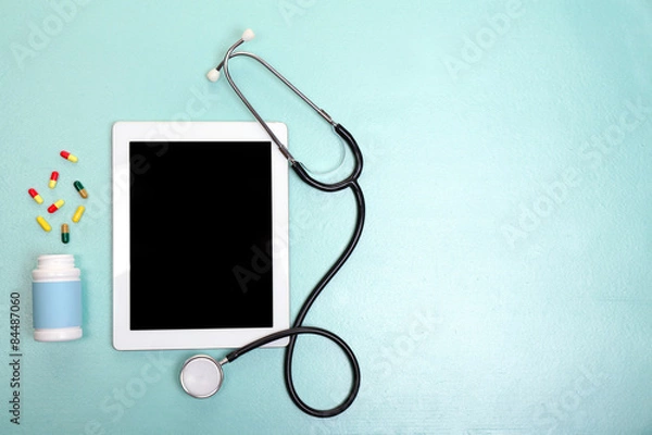 Fototapeta Medical tablet with stethoscope on blue background