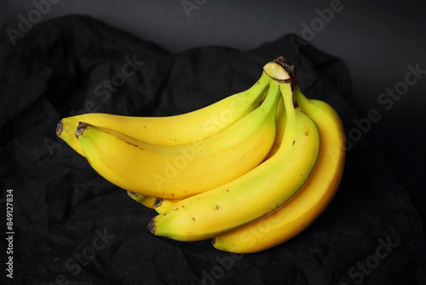 Fototapeta Ripe yellow bananas on a dark background