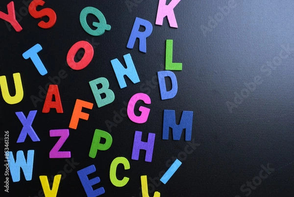 Fototapeta colorful letter alphabet on black background, object for education