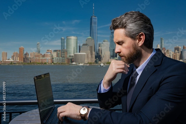 Fototapeta Business man using laptop pc outdoor in New York. American success Businessman . Remote freelance work. Online business in US. Business success. Management strategy. Outside business.