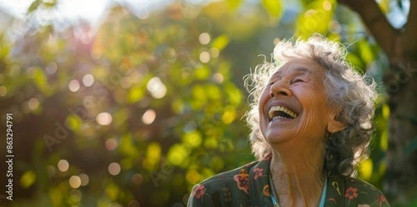 Fototapeta Beautiful elderly woman laughing in the garden with gray hair