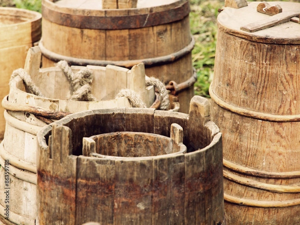 Fototapeta A lot of old wooden buckets and barrels taken closeup.