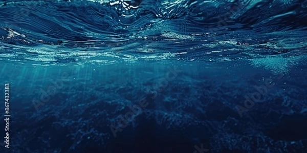 Fototapeta A wave crashes into the camera in a vast, blue ocean scene