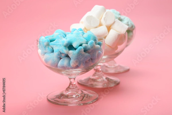 Fototapeta Fluffy candies in glassware on pink background