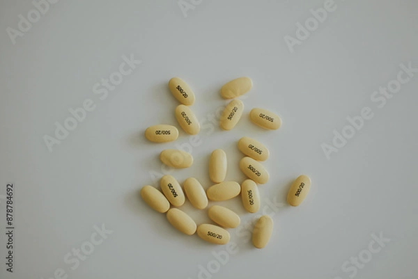 Fototapeta yellow pills on a white background