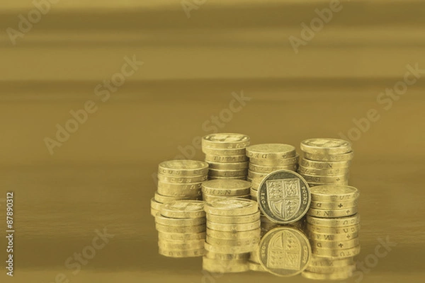 Fototapeta british one pound coins on gold background