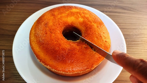 Fototapeta Traditional brazilian cornmeal cake being sliced
