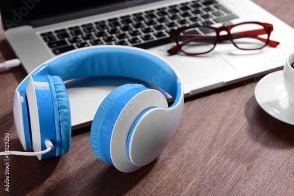 Fototapeta Workplace with headphones on table close up