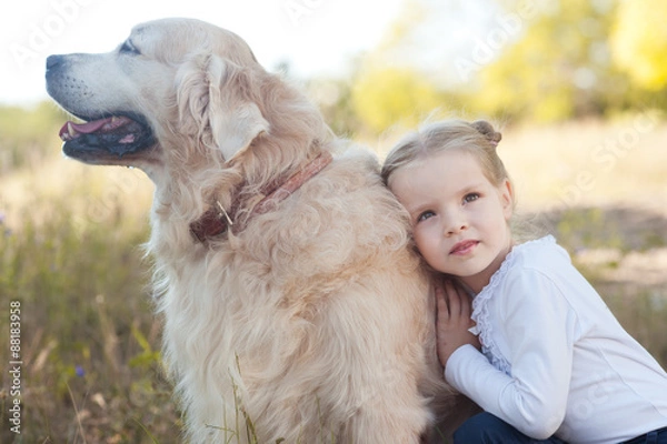 Fototapeta Cute baby girl 3-4 year old with pet outdoors. Childhood.